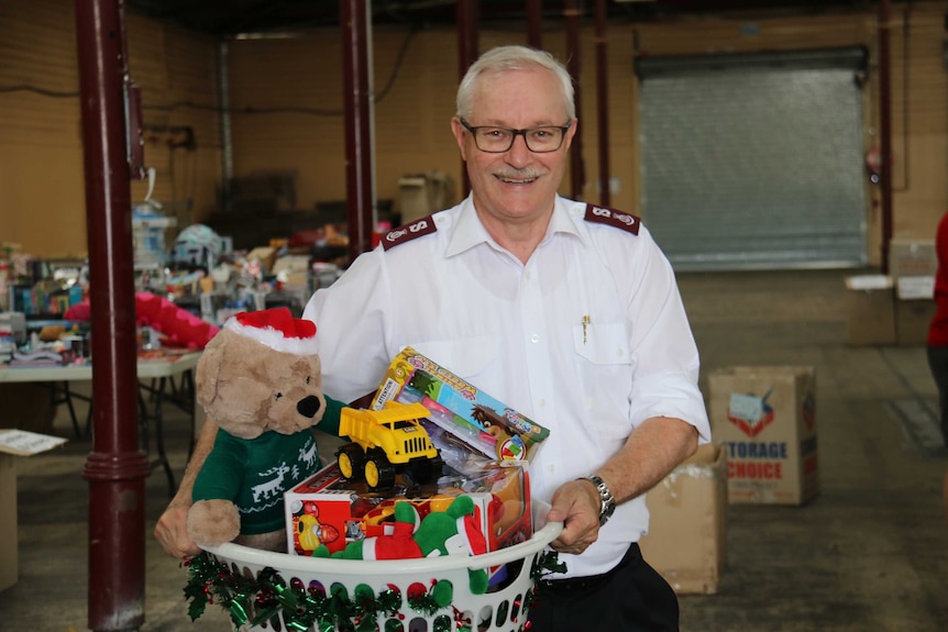 Salvation Army's Major Neil Dickson holding a basket of toys