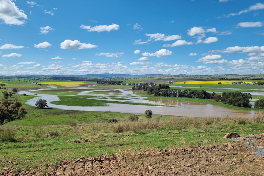 Flood water lays on river flats, inundating crops.