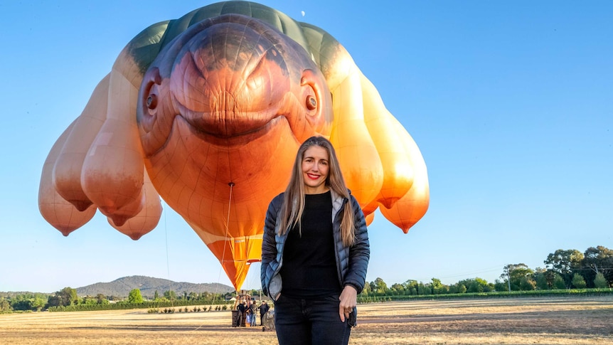 Artist Patricia Piccinini stands in front of her giant balloon creation, Skywhale.