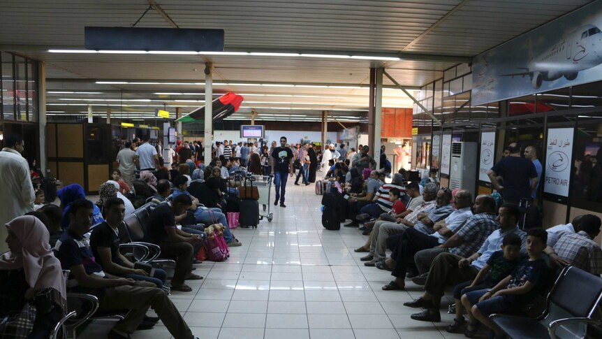 Passengers wait at Tripoli's Mitiga airport