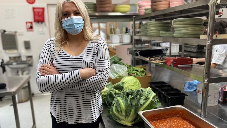 a woman in a cafe kitchen with food