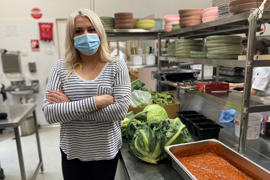 a woman in a cafe kitchen with food