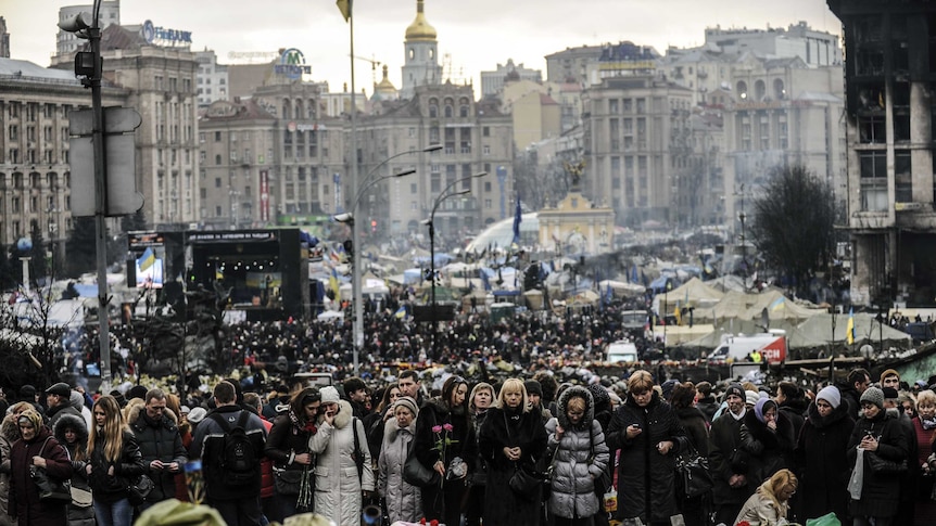 Crowds visit Kiev's Independence Square to mourn those killed in the recent political violence.