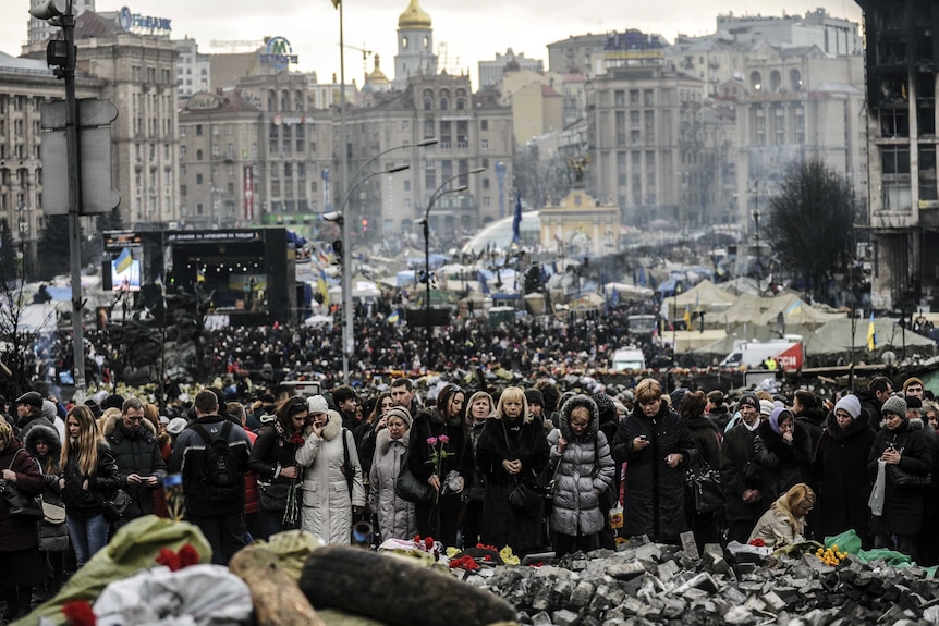 Crowds visit Kiev's Independence Square to mourn those killed in the recent political violence.