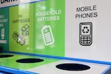 A photo of an e-waste collection bin for used phones, batteries and ink cartridges.