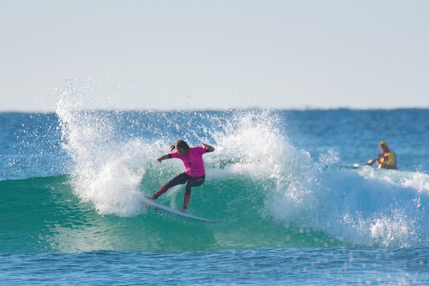14-year-old Casuarina surfer Zahli Kelly performs a slashing turn.