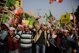 Indian farmers wave flags and shout in protest against low food prices.