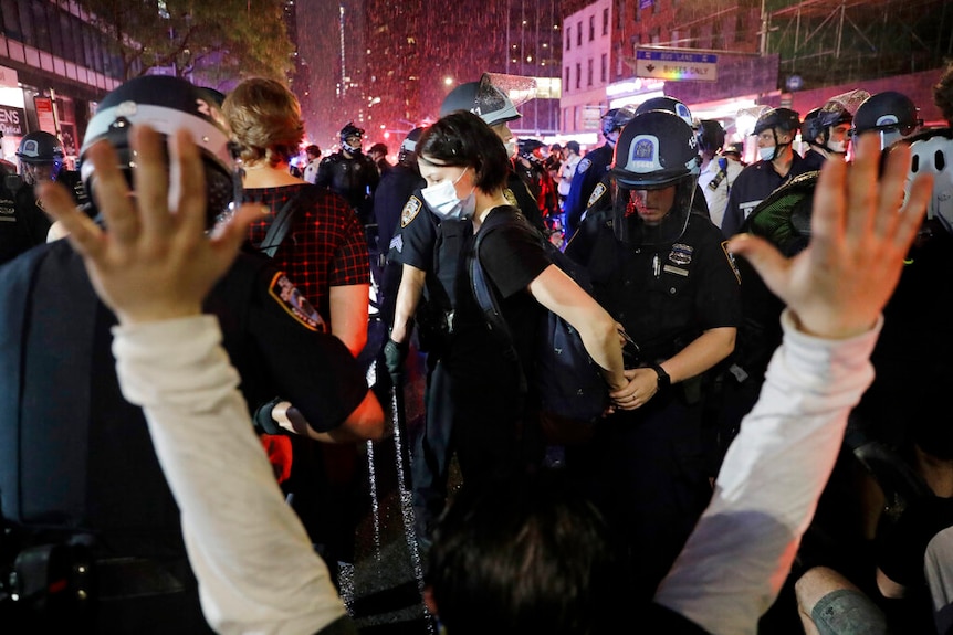 Police arrest protesters as they march through the streets of Manhattan.