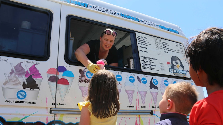 Sarah Wicken giving children ice-cream from her truck