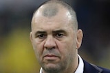 A coach watches his team warm up before the Australia versus England Rugby World Cup match.