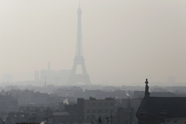 The Eiffel Tower seen through thick smog.