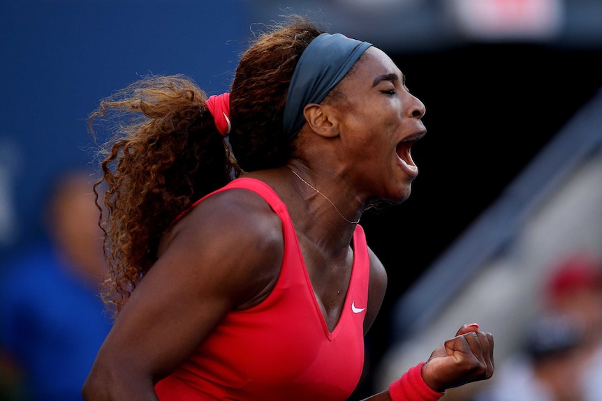 On top ... Serena Williams celebrates during the first set