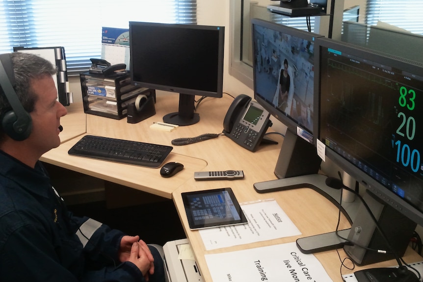 A health worker observes a patient in a hospital bed through the new telehealth service trial rolled out in Canberra.