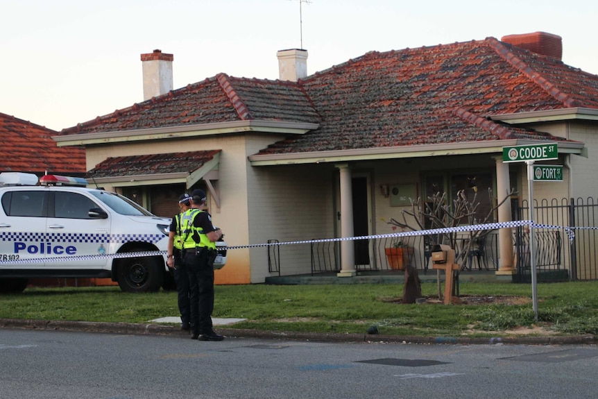 A brick and tile house with police tape, a police car and two officers out the front.