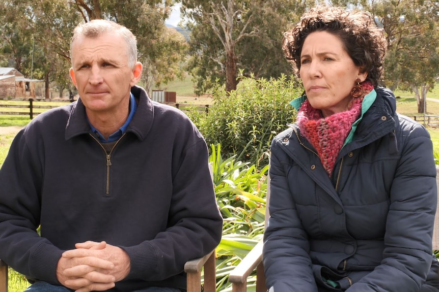 Two people sit side by side in an interview.