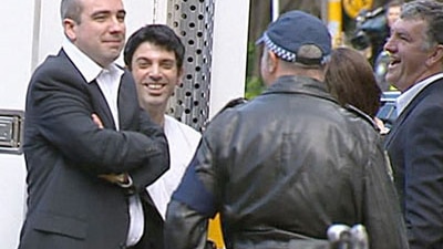 The Chaser's Julian Morrow and Chas Licciardello with police after the fake motorcade sketch/ABC TV.