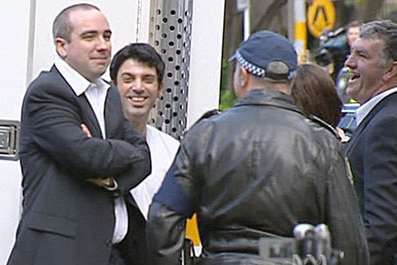 The Chaser's Julian Morrow and Chas Licciardello with police after the fake motorcade sketch/ABC TV.