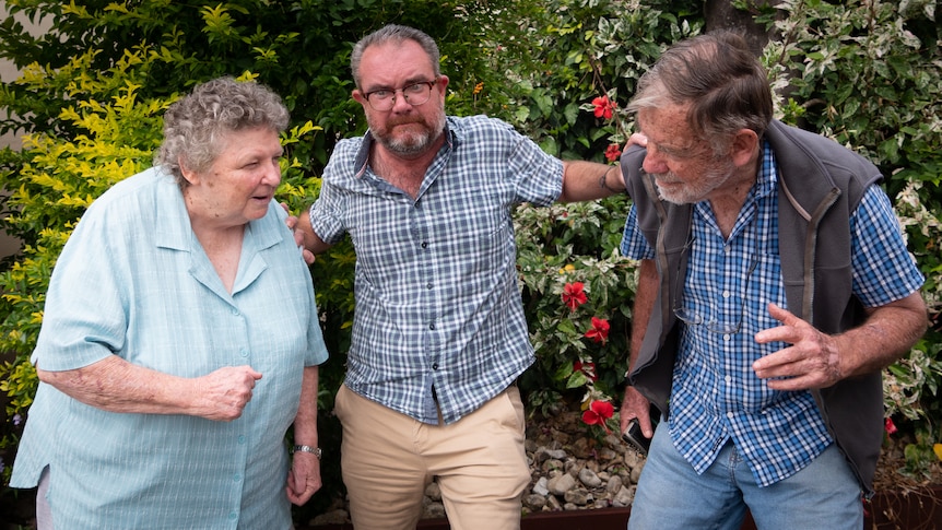 Kier Shorey in the center holding back Meg Trible and David Howard from fighting with each other 