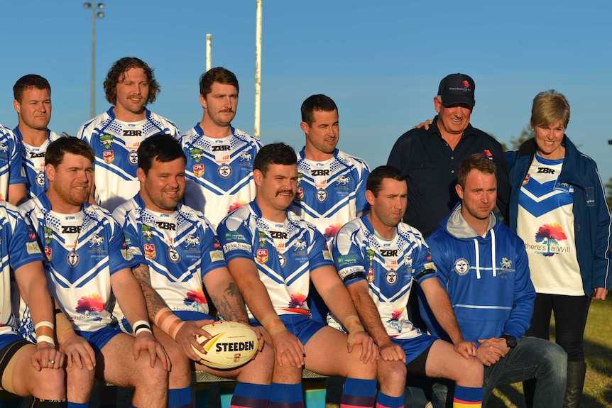 Hilton and Pauline Carrigan stand with rugby players