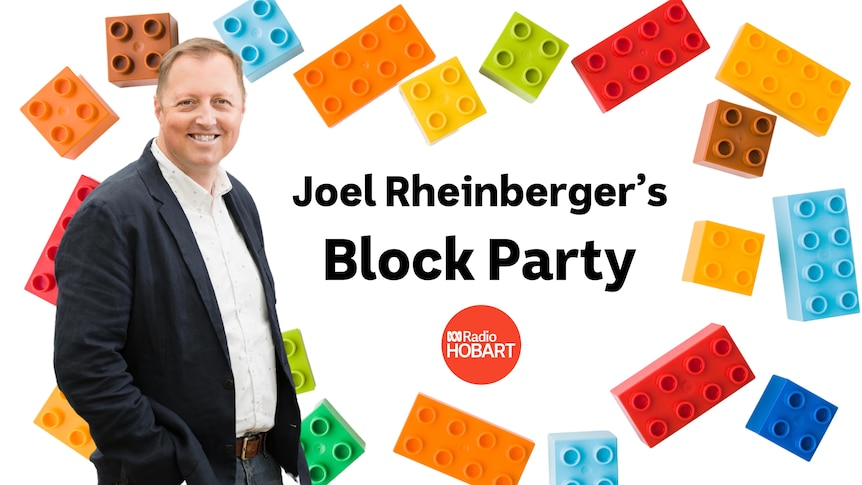 Joel Rheinberger stands in front of coloured lego blocks 