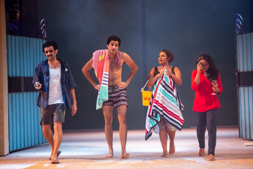 Four young people - three South Asian and one First Nations - walk on a stage in summer clothes