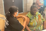 Vaccine nurse administering the Pzifer shot to Cherbourg local in Pfizer pop up clinic