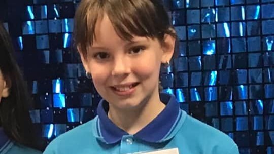 Charlise in her school uniform