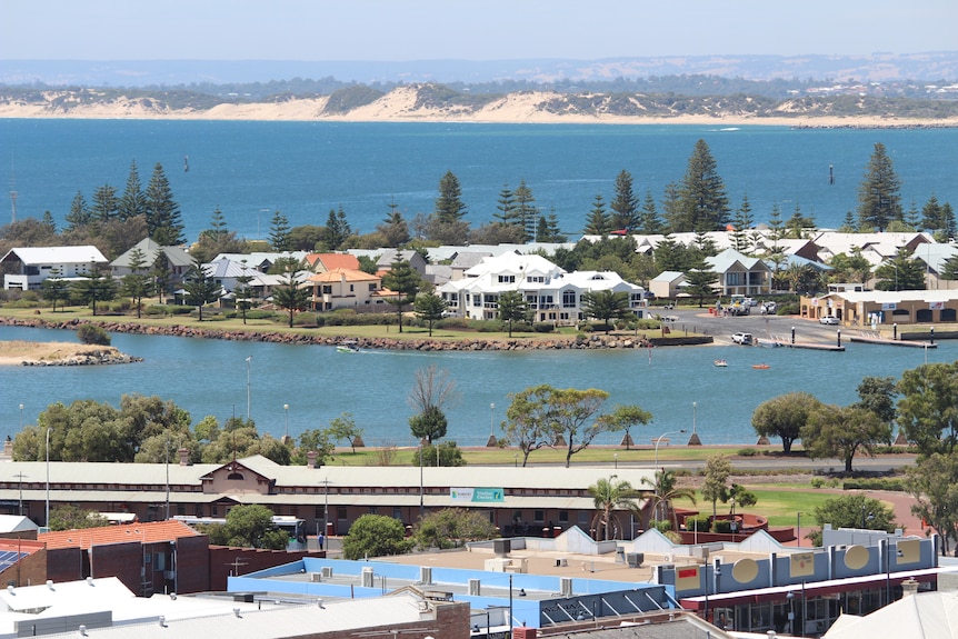 A long shot of a coastal town including a beach and inlet