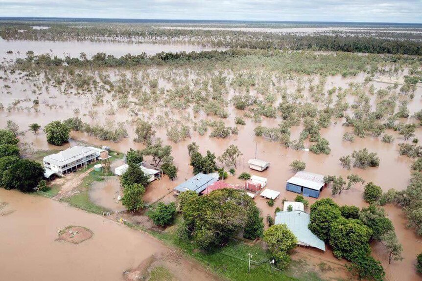 Muddy water surrounding an outback station aerial shot.