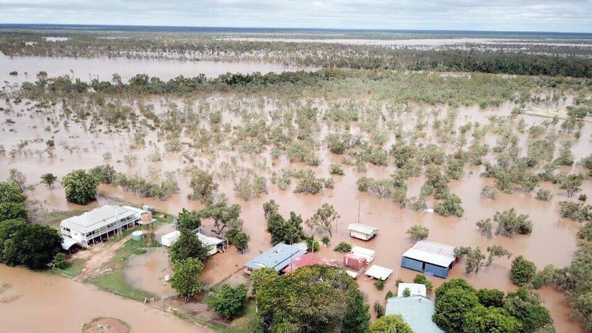 Muddy water surrounding an outback station aerial shot.
