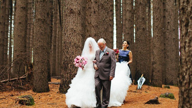 Batlow resident Cor Smit walking his daughter down the aisle at her wedding in the Sugar Pine forest