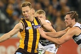 Hawthorn's Sam Mitchell looks to kick against Geelong