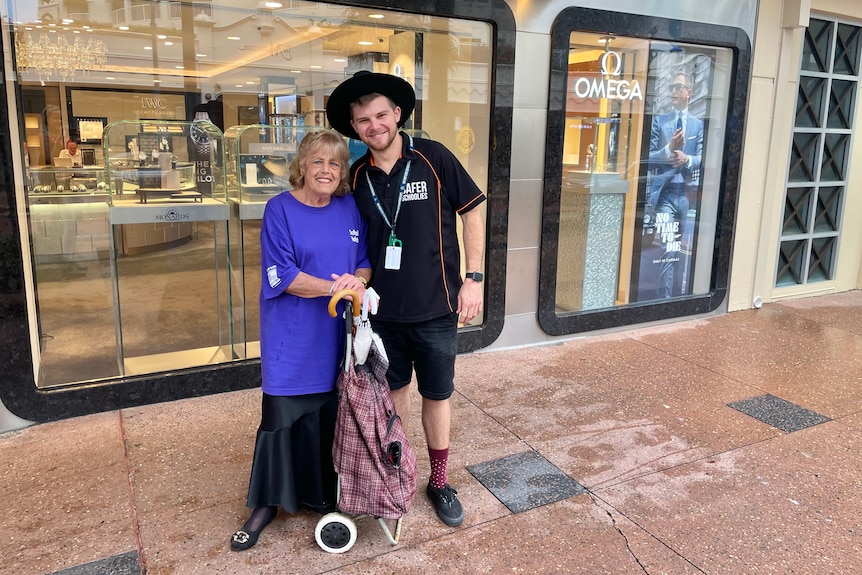 An elderly woman and a young man, smiling