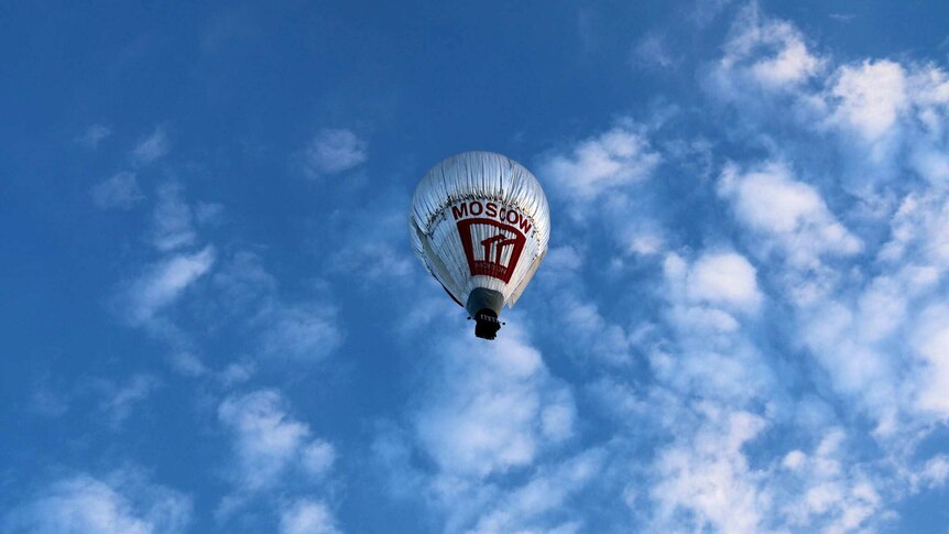 A hot-air balloon in the blue sky.