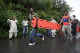 Rescue workers run to Pakistan plane crash site