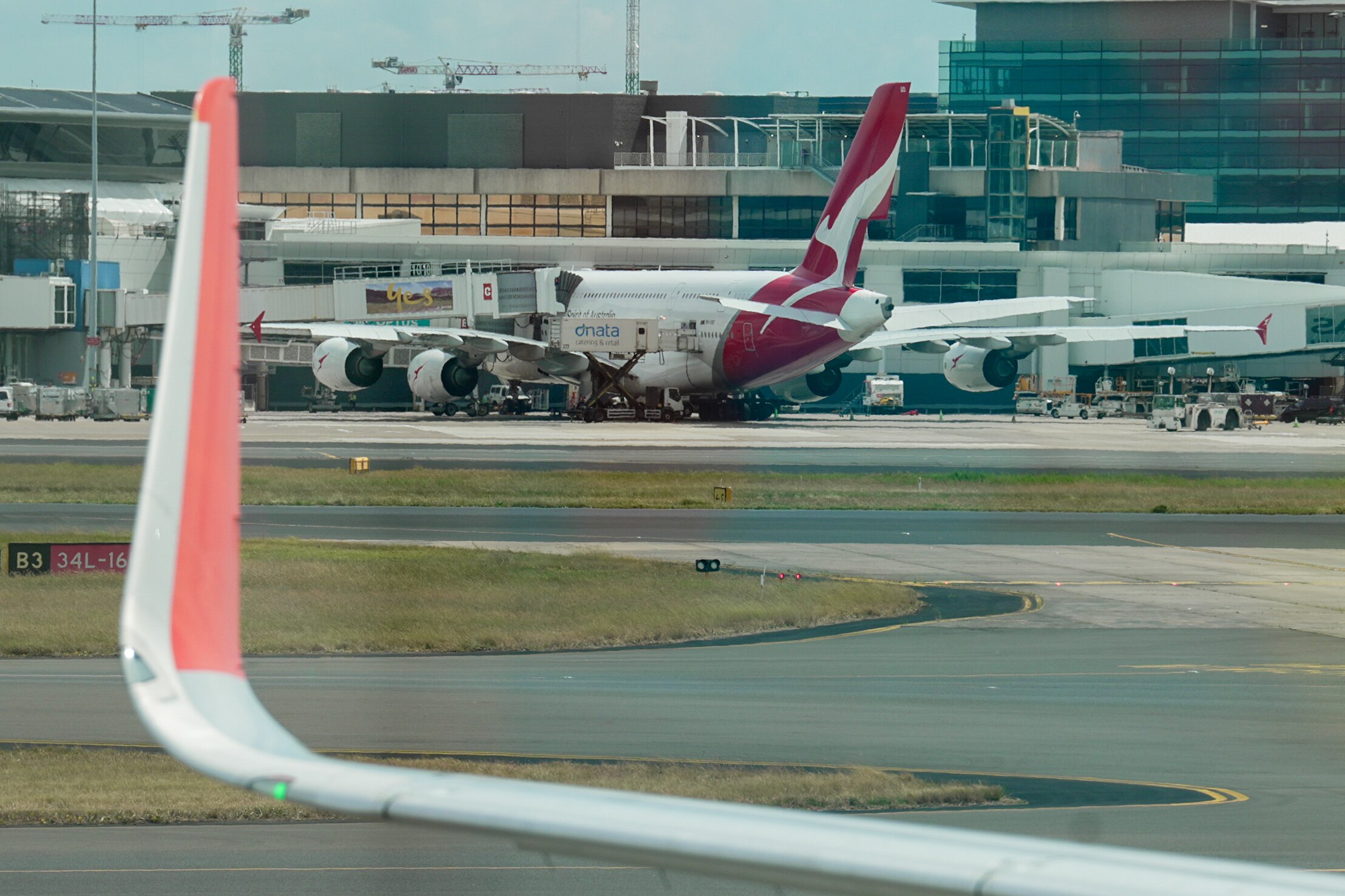 A Qantas plane on the runway at Sydney Airport.