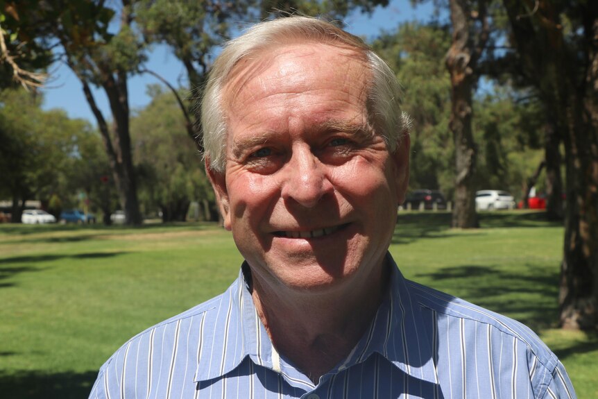 A head and shoulders shot of former WA premier Colin Barnett smiling outdoors.