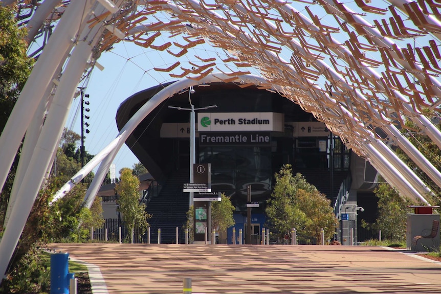 The outside of the station is decorated in boomerang-shaped pieces of wood, strung on bits of wire between steel strutts.