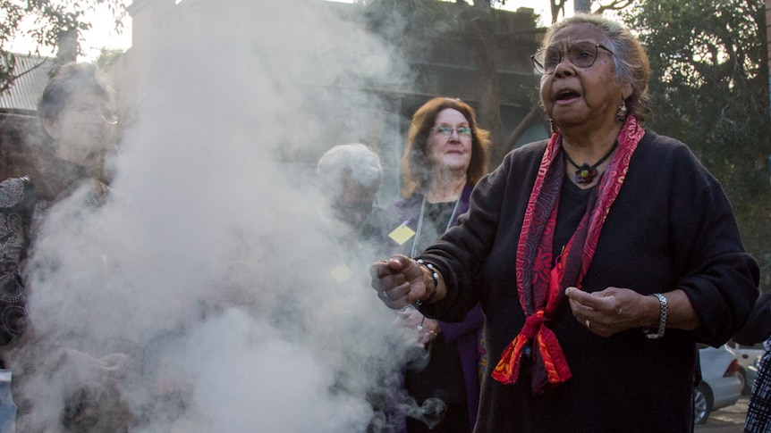 Aunty Ali Golding performing a smoking ceremony