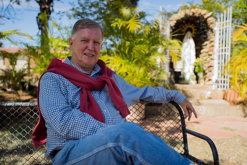 Father Mick Lowcock in churchyard of his Mount Isa Catholic parish