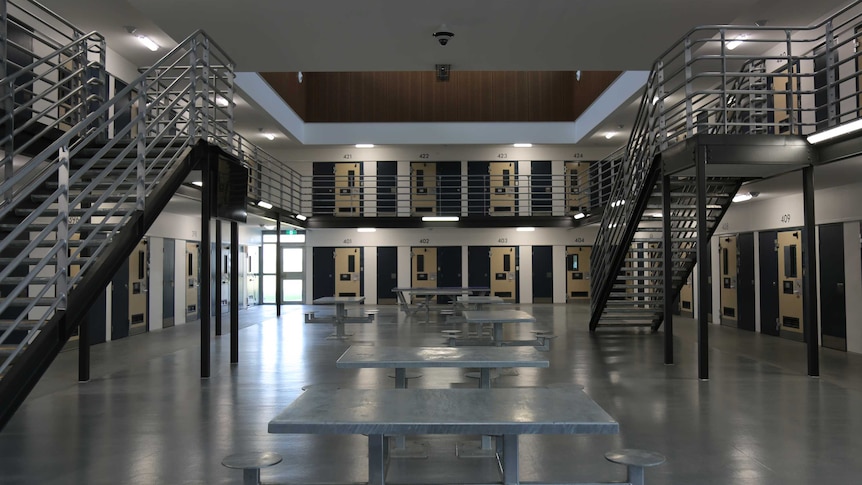 A two storey jail wing, showing stairs leading to the second level of cells.
