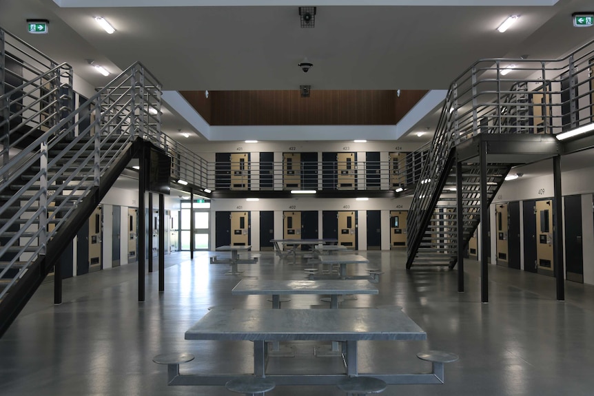 A two storey jail wing, showing stairs leading to the second level of cells.