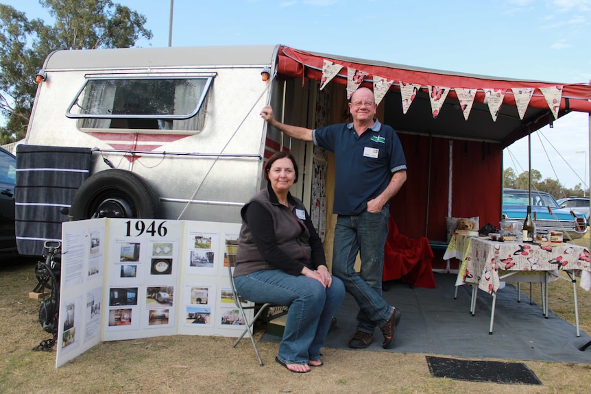 A couple beside their 1946 retro van and anex.