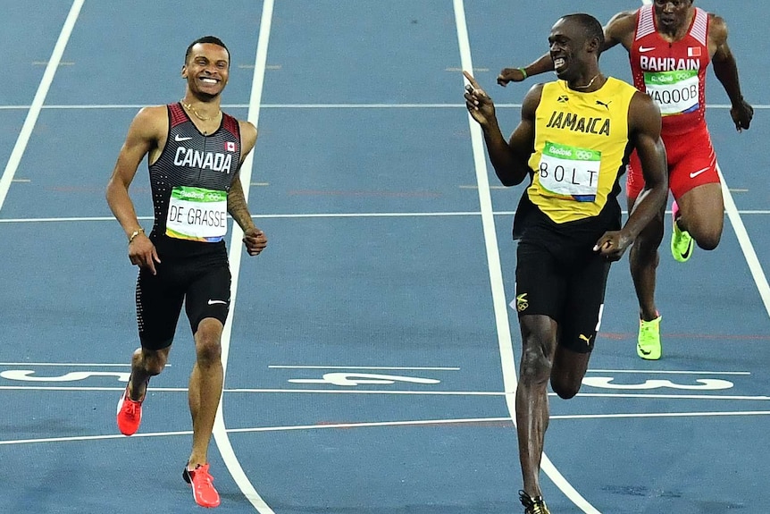 Usain Bolt and Andre De Grasse after the 200m semi-final