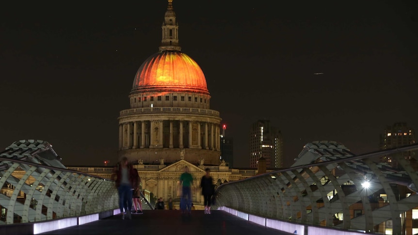 St Paul's Cathedral lit up with a fiery projection