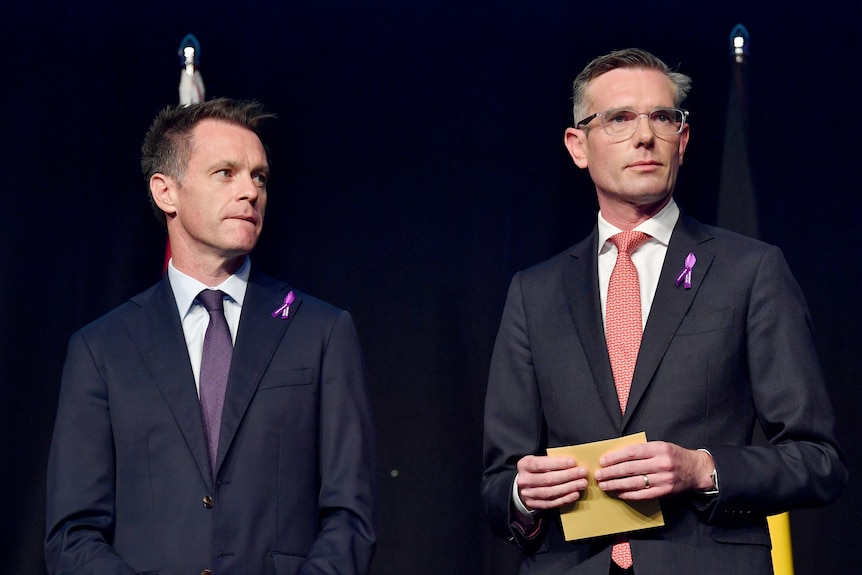 Two men standing in suits