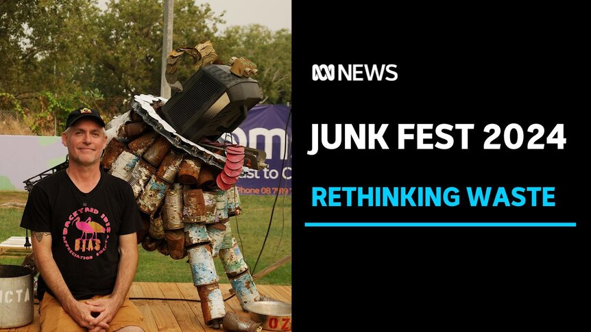 Junk Fest 2024, Rethinking Waste: A man posing in front of a statue made from recycled material.