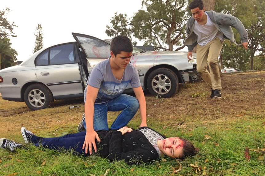 School students perform the roles of accident victims in an RACQ docudrama