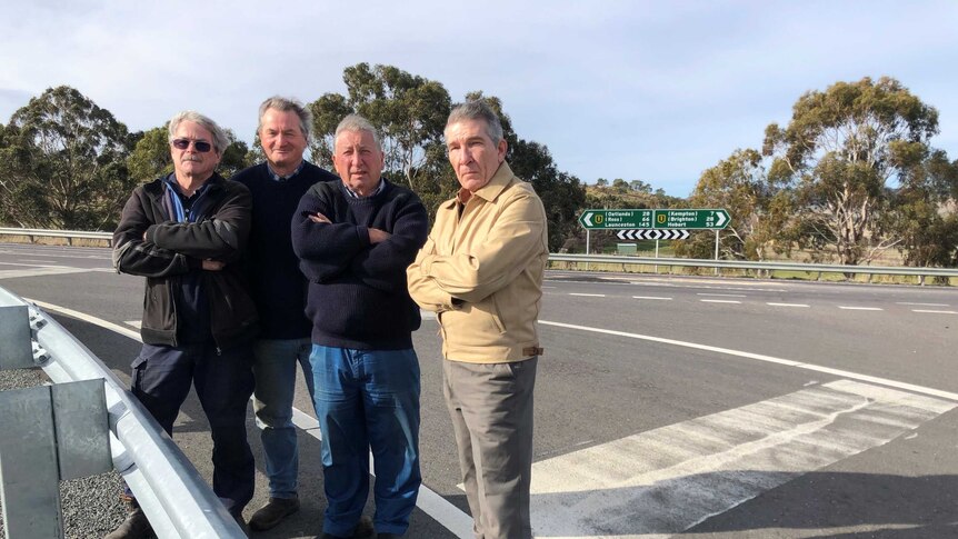 Four Melton Mowbray locals stand at intersection.