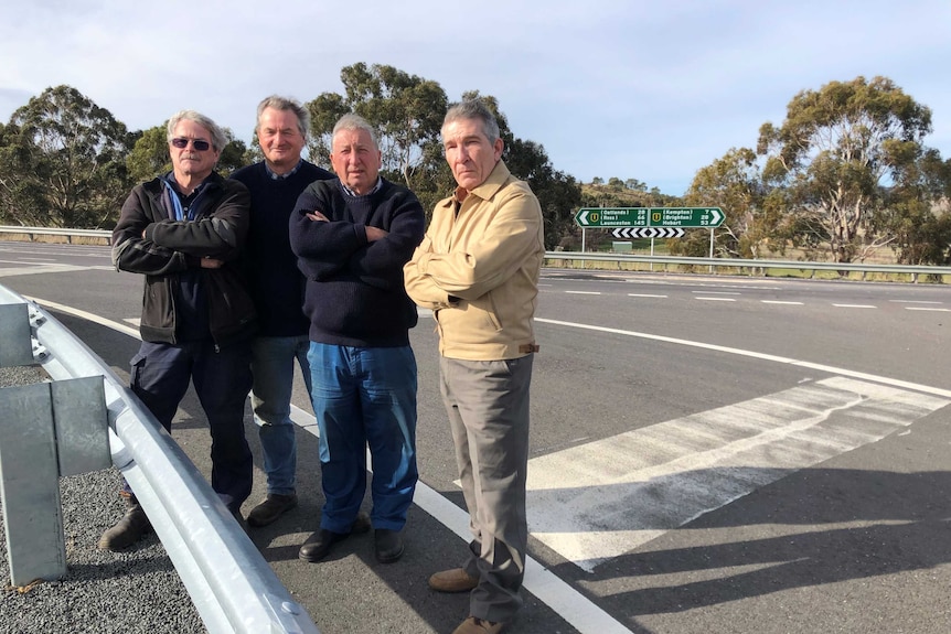 Four Melton Mowbray locals stand at intersection.
